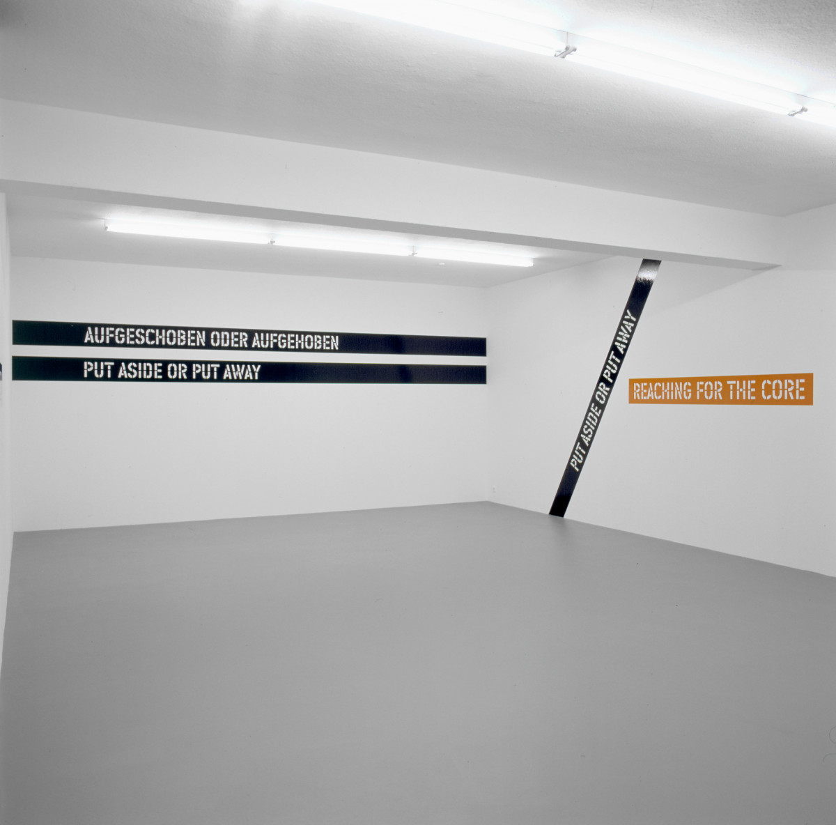 Lawrence Weiner, ‘AUFGESCHOBEN ODER AUFGEHOBEN NACH DEM KERN GREIFEN PUT ASIDE OR PUT AWAY REACHING FOR THE CORE’, Installation view, Buchmann Galerie, 2002